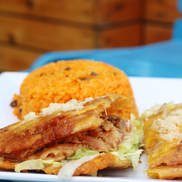 Ponce Restaurant's Puerto Rican mofongo with shredded pork, lettuce, and a side of orange rice.