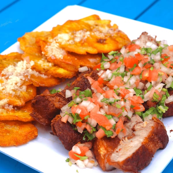 Ponce Restaurant's Puerto Rican dish with fried pork chunks, tostones, and a fresh tomato and onion salsa.
